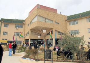 Students gather in front of one of the Dohuk University campus buildings