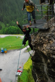 Jessica Festa jumping into a canyon in the Swiss Alps