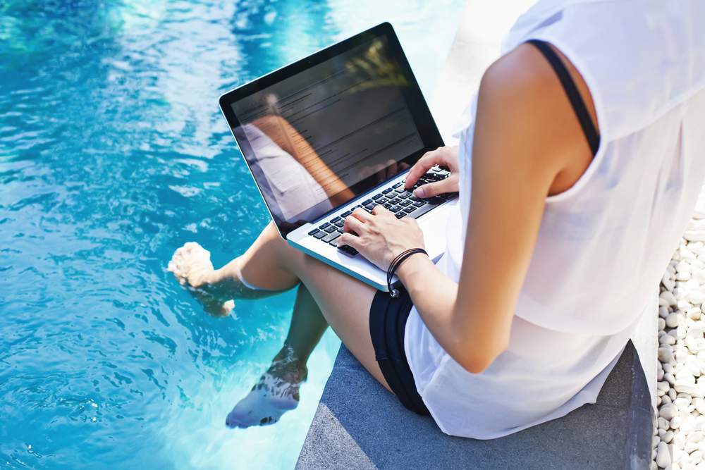 Digital Nomad working by the pool