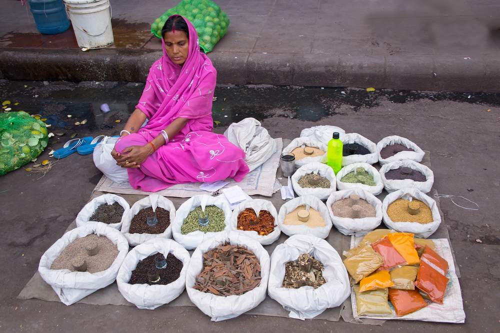 Woman selling spices on the street in New Delhi, India